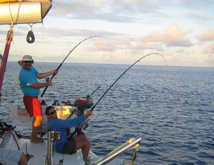 Steve and one of the other lads being played by yellowfin tuna.  Note the spinning rod and fixed spool reel.