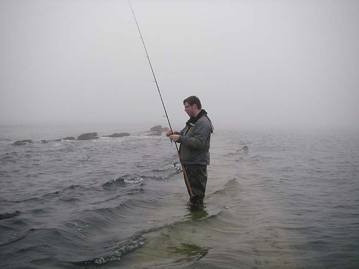 Ben pauses to clear a bit of weed off the lure.  My fish was hooked on the other side of the rocks that are sticking up.