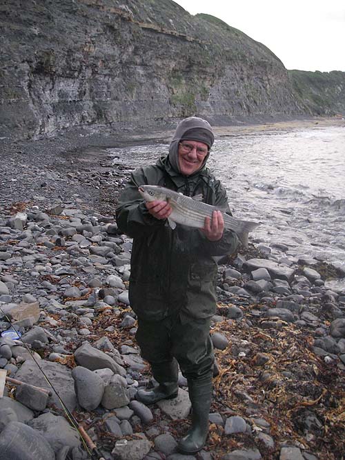 Ben was kind enough to take a picture of me with the fish before I returned it to the sea.  It was hooked just where the waves are turning over in the edge.