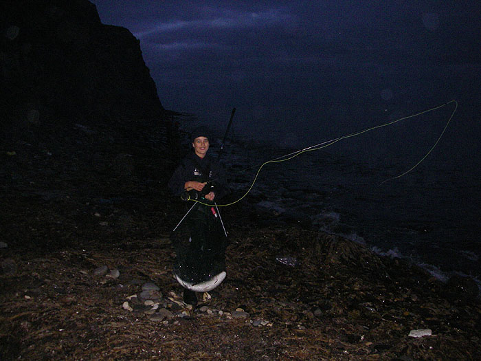 Jamie trudges back in near darkness, lugging rod and net to show the others his first mullet on the fly.