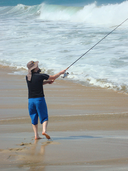 Richard tries to bang a lure out beyond the surf.
