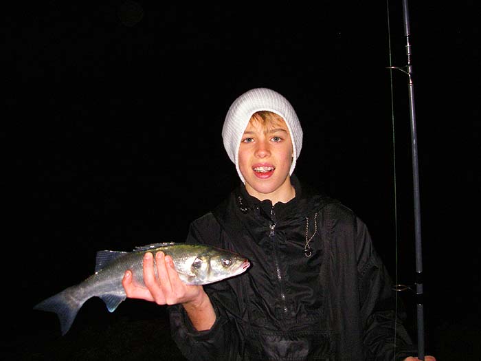 Young Ben with a lure caught bass at the crack of dawn.