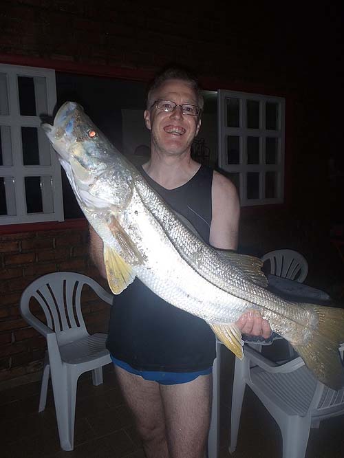 That's what I call a snook.  Wonderful sport and popular food fish in Brazil.  No wonder he looks pleased.