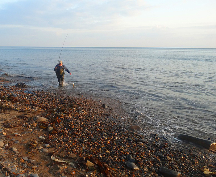 Bill took this picture of me beaching one of my Mepps caught bass.