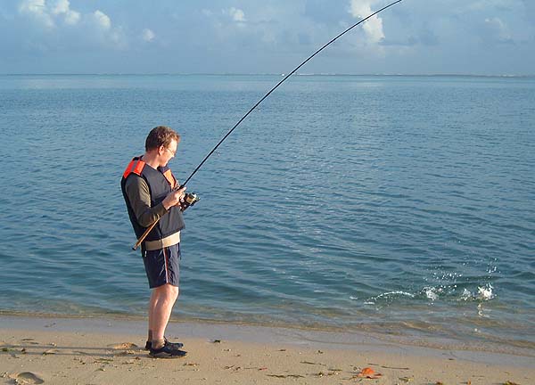 Rich is into a small barracuda.  Note the buoyancy vest - an insurance against deep holes encountered when wading.