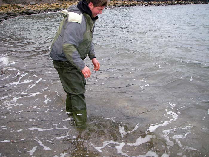 Ben straightens up after returning his largest fish - still visible at his feet.