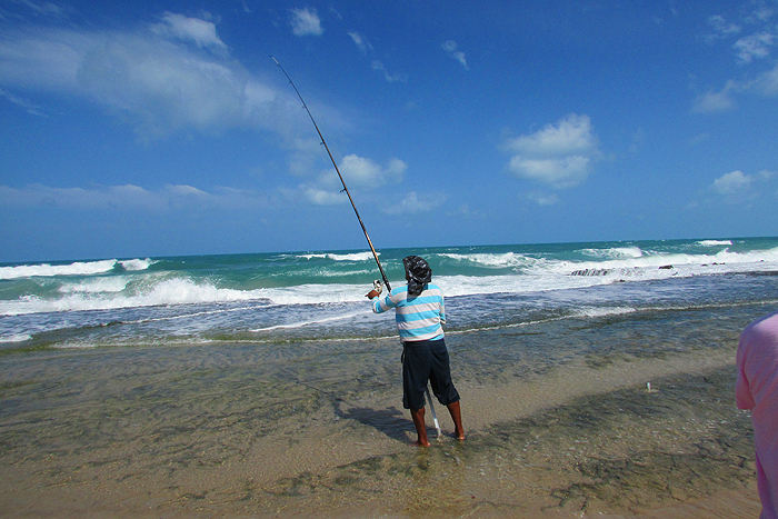 A local angler using one of the permanent rod rests.  Another one is visible a little to his right.