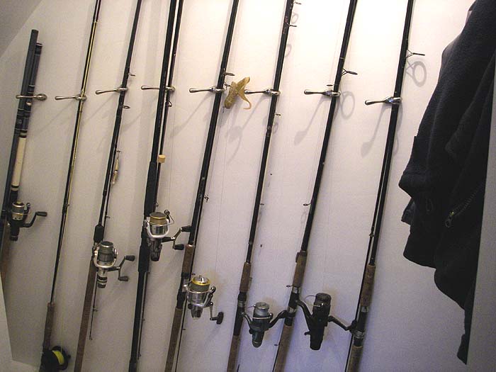 My rods with reels, lines and lures attached sit (fairly) neatly along the wall. Coats and boots to the right.