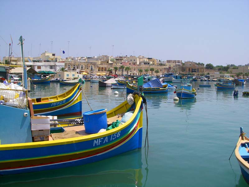 The fishing boats are even more brightly coloured than the fish.